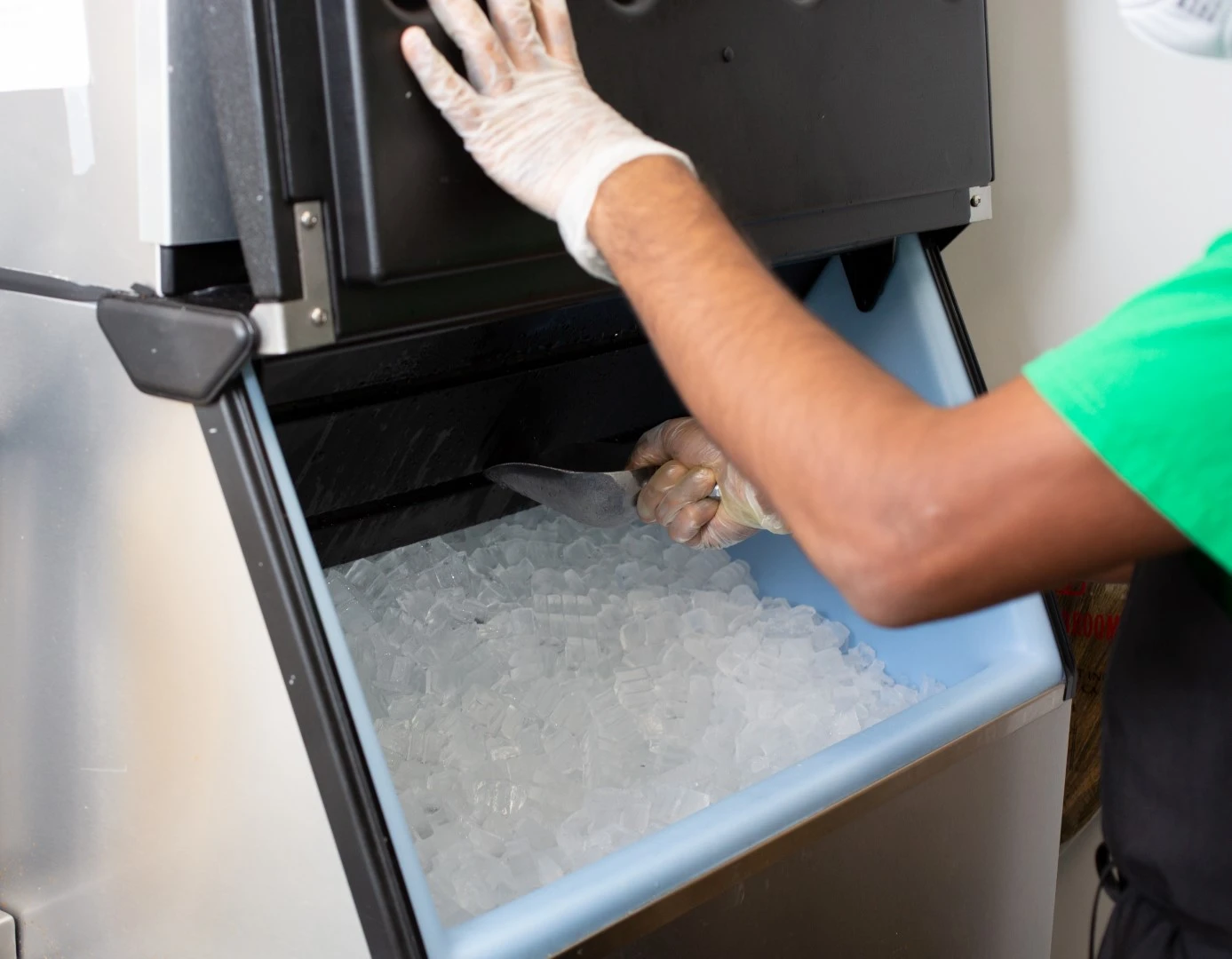 Lady taking ice from a Manitowoc, ITV, or Scotsman ice machine supplied by GOLDEN AGE HOUSING PRODUCTS