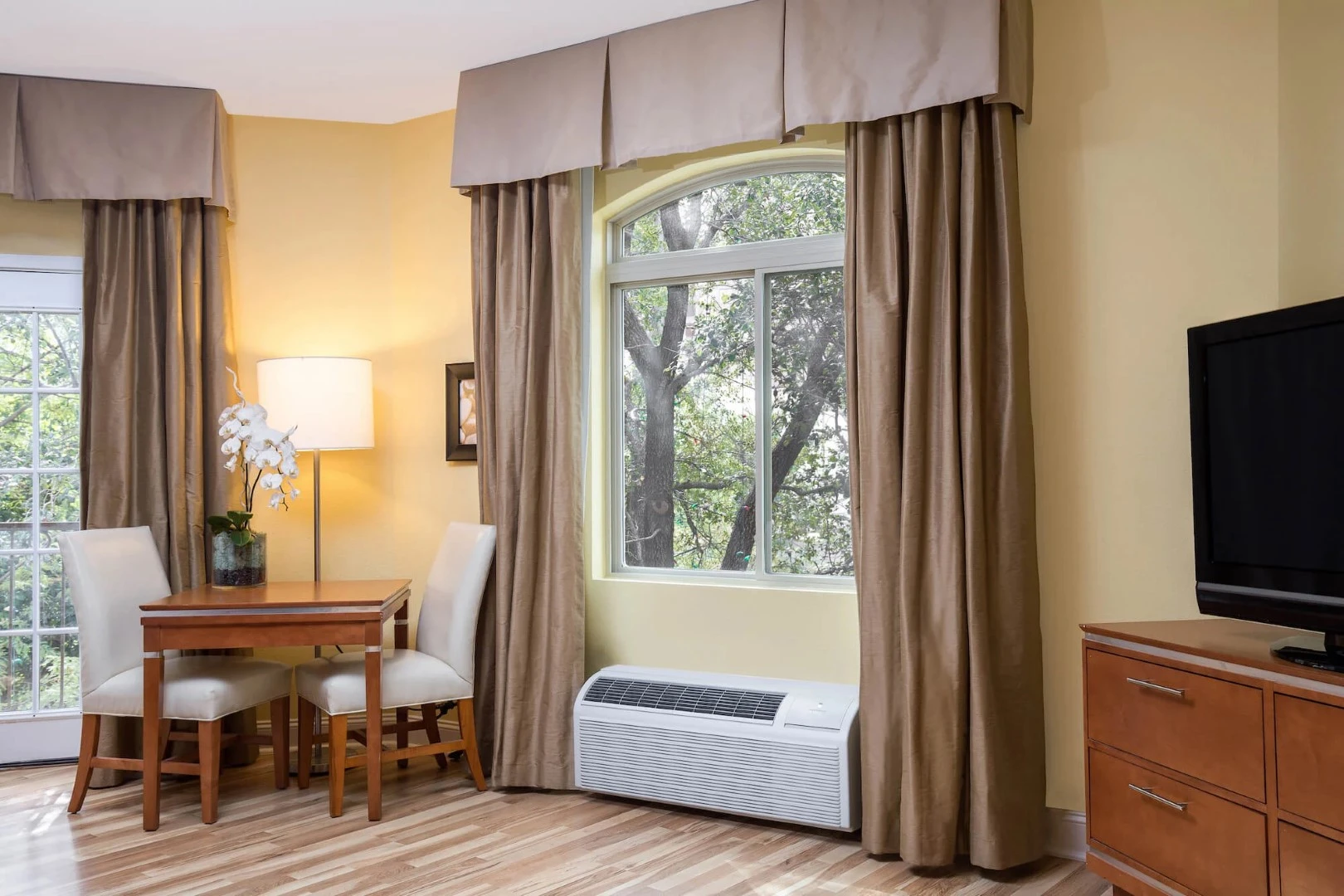 Hotel room with visible HVAC unit under the window supplied by GOLDEN AGE HOUSING PRODUCTS